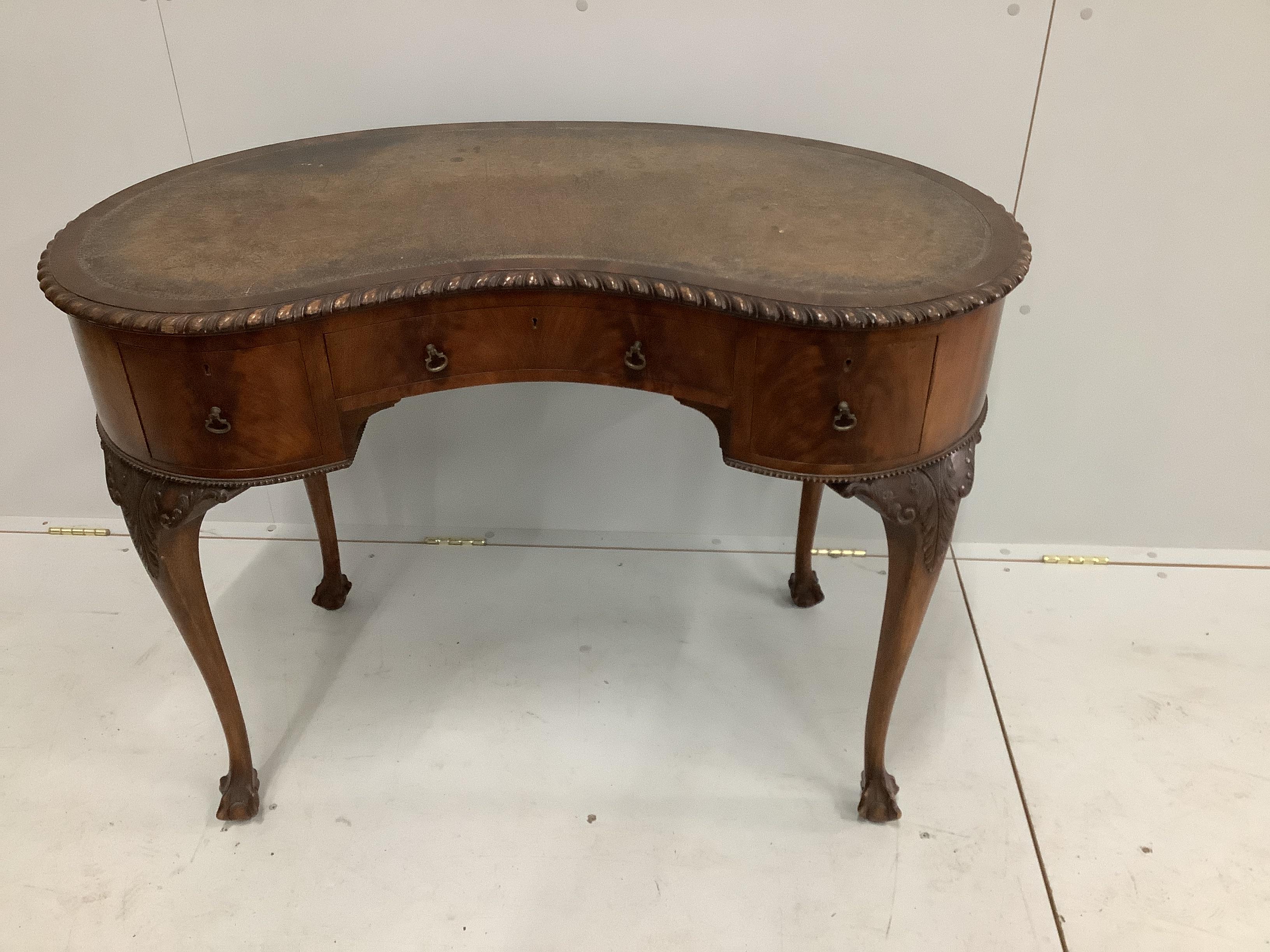 An early 20th century Chippendale revival mahogany kidney shape writing table, width 106cm, depth 60cm, height 77cm